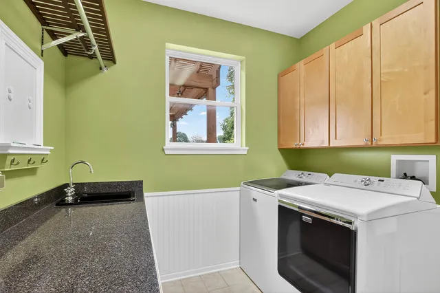 a utility room with a sink a washer and dryer
