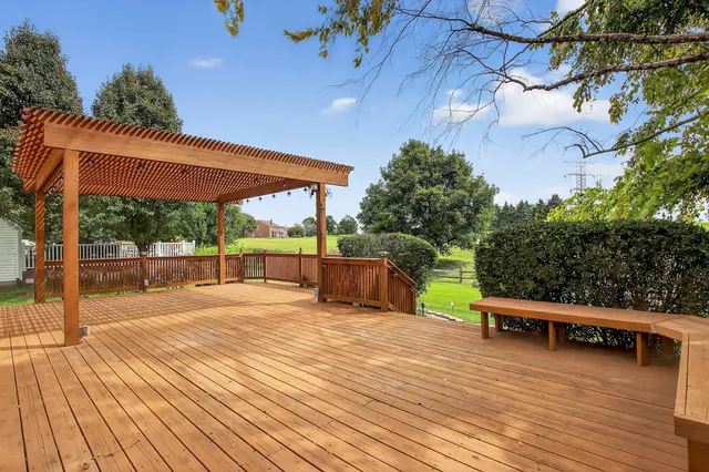 a view of a swimming pool with a patio and a yard