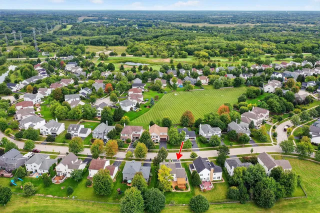 an aerial view of residential houses with outdoor space and swimming pool