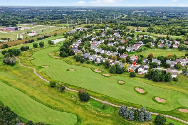 an aerial view of a golf course with a huge green field