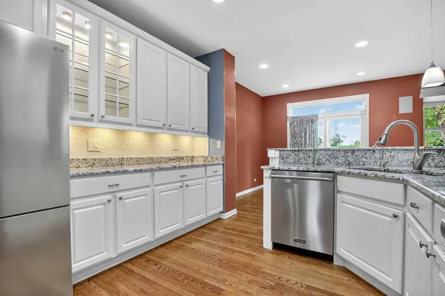 a kitchen with stainless steel appliances granite countertop a sink and stove top oven