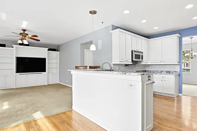 a kitchen with kitchen island a sink stainless steel appliances and cabinets