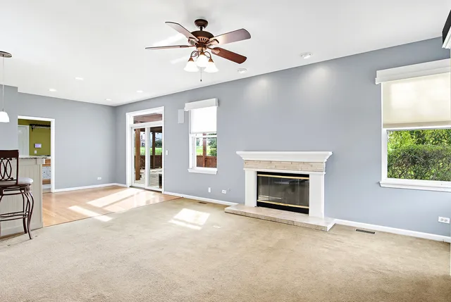 a view of an empty room with a fireplace and a window
