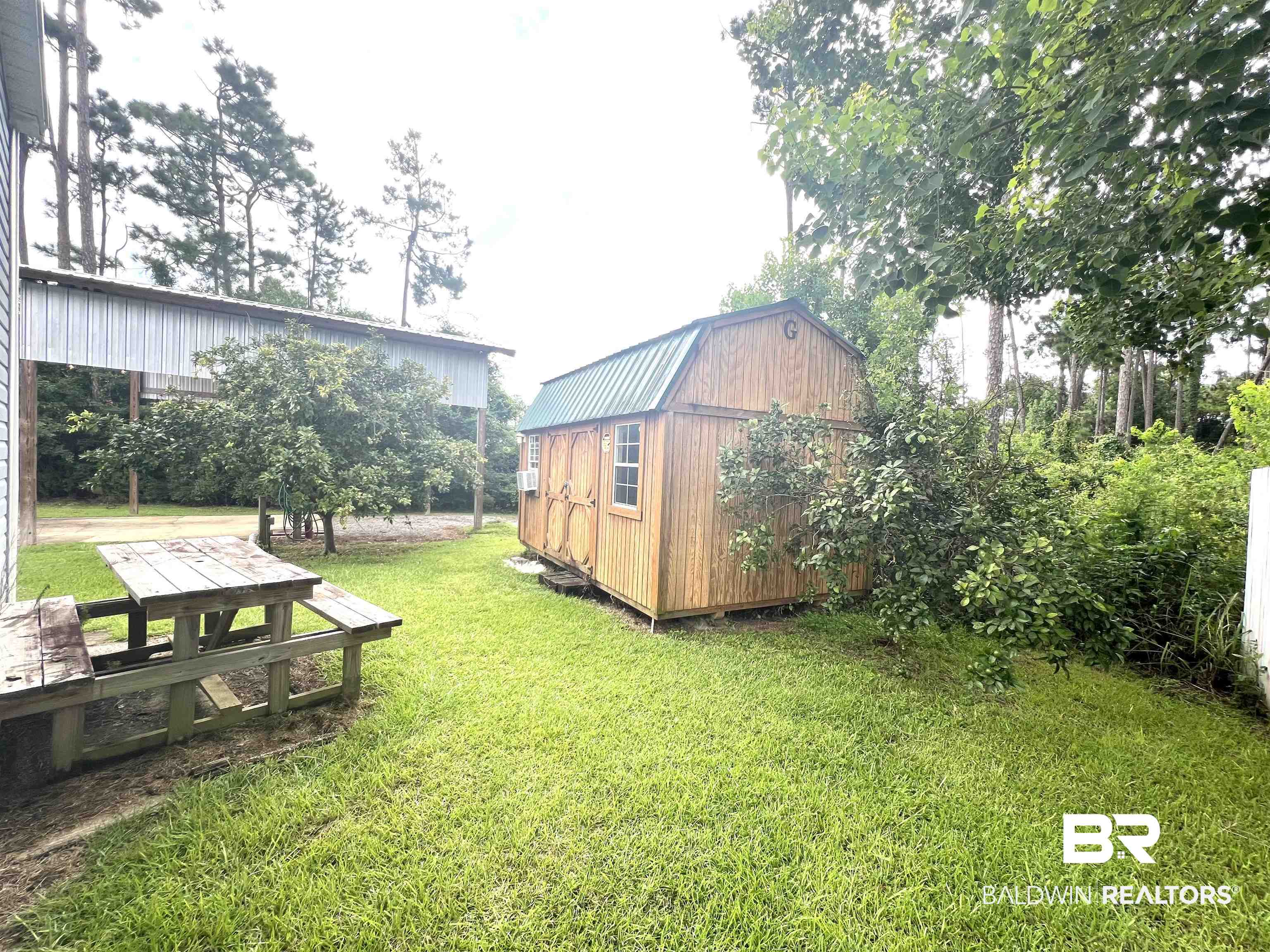 662 Escambia Loop Lillian, AL 36549 - Photo 7 of 26 View of yard with a shed