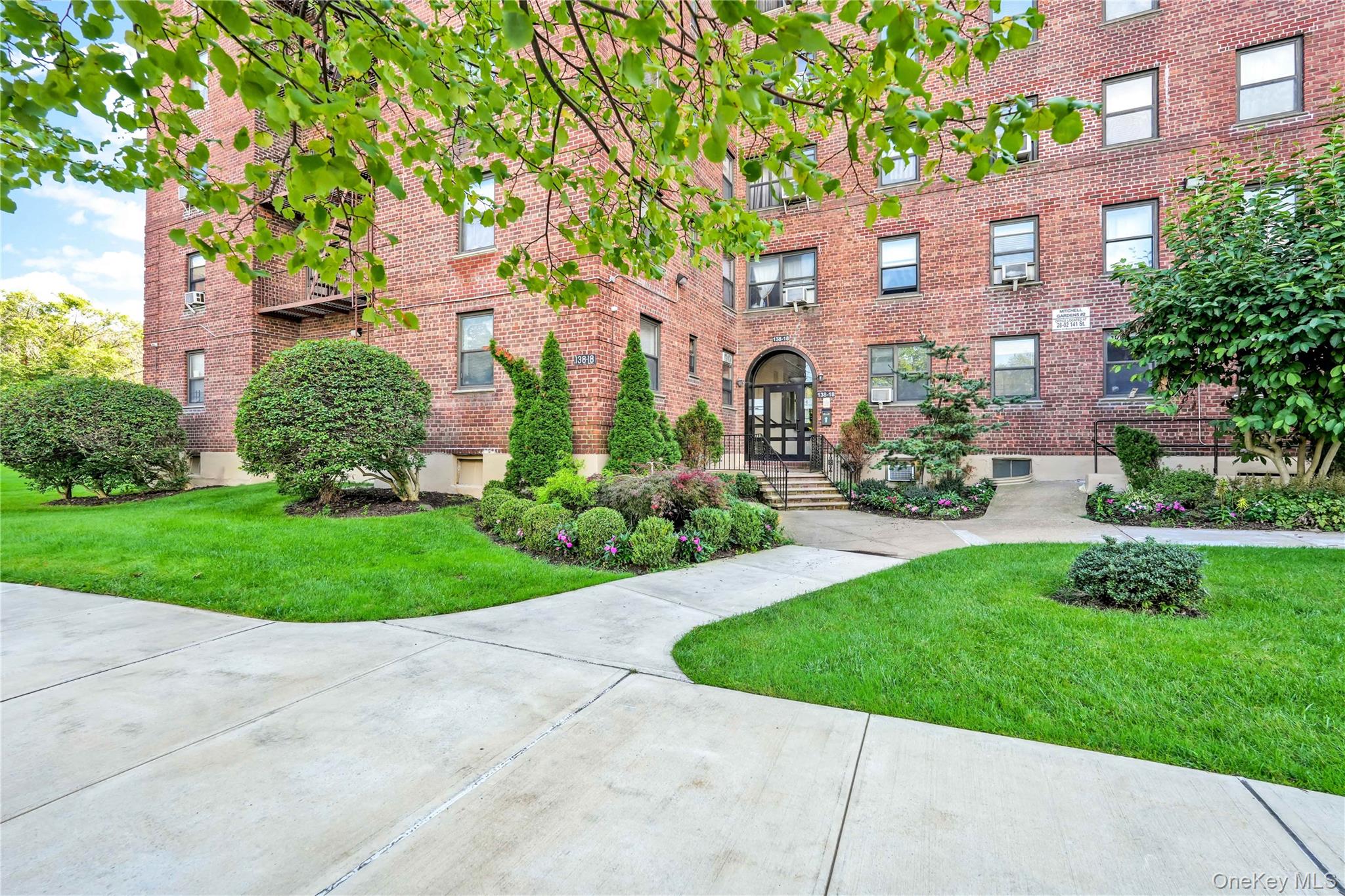 138-12 28th Road, Unit 1F Queens, NY 11354 - Photo 8 of 8 a front view of a multi story building with yard
