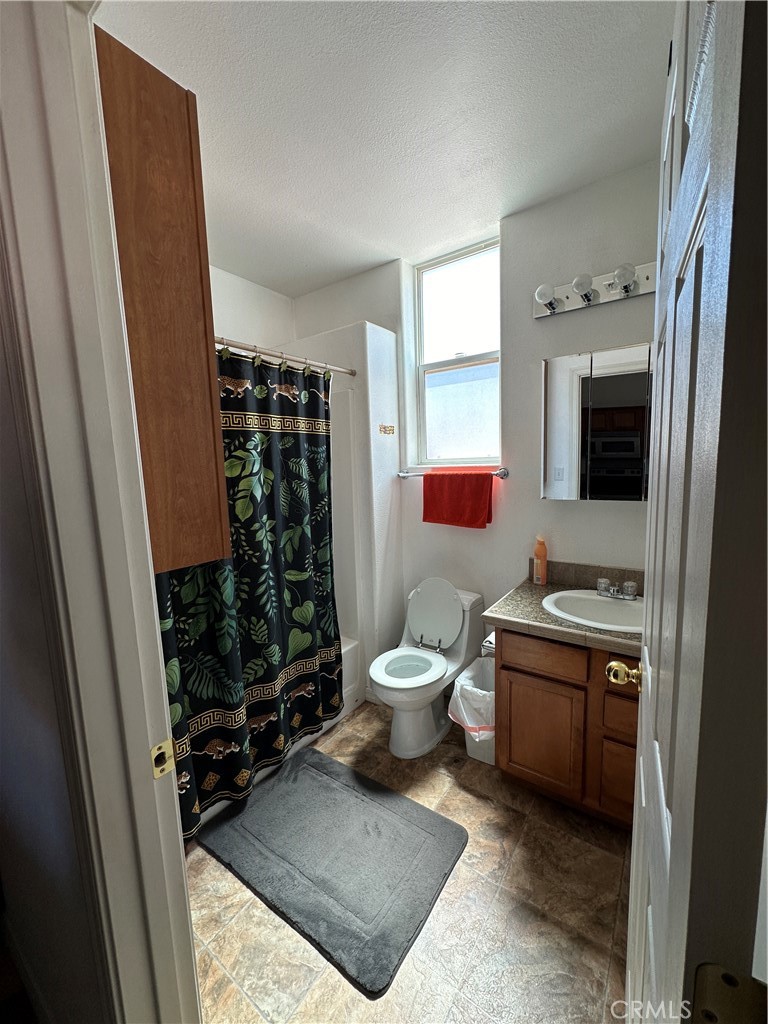 1100 Beach Drive Needles, CA 92363 - Photo 11 of 13 a room with a toilet a sink and a mirror