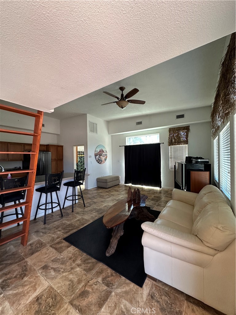 1100 Beach Drive Needles, CA 92363 - Photo 7 of 13 a living room with furniture and a flat screen tv