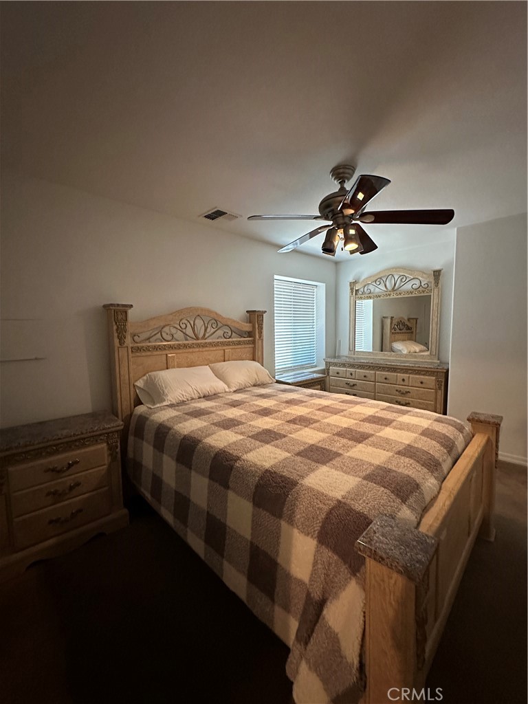 1100 Beach Drive Needles, CA 92363 - Photo 10 of 13 a bedroom with a bed and a chandelier