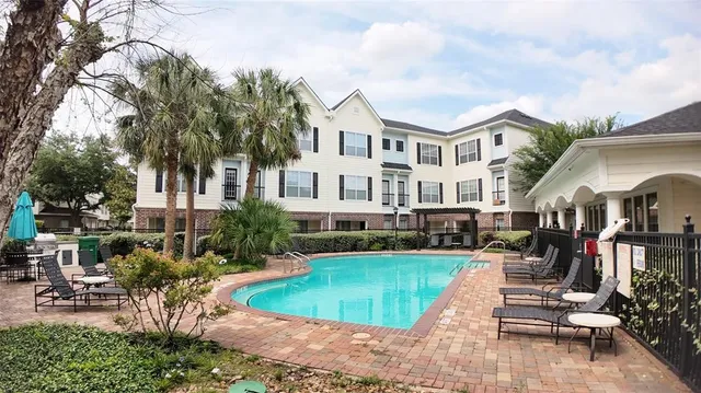 a view of a house with swimming pool and sitting area