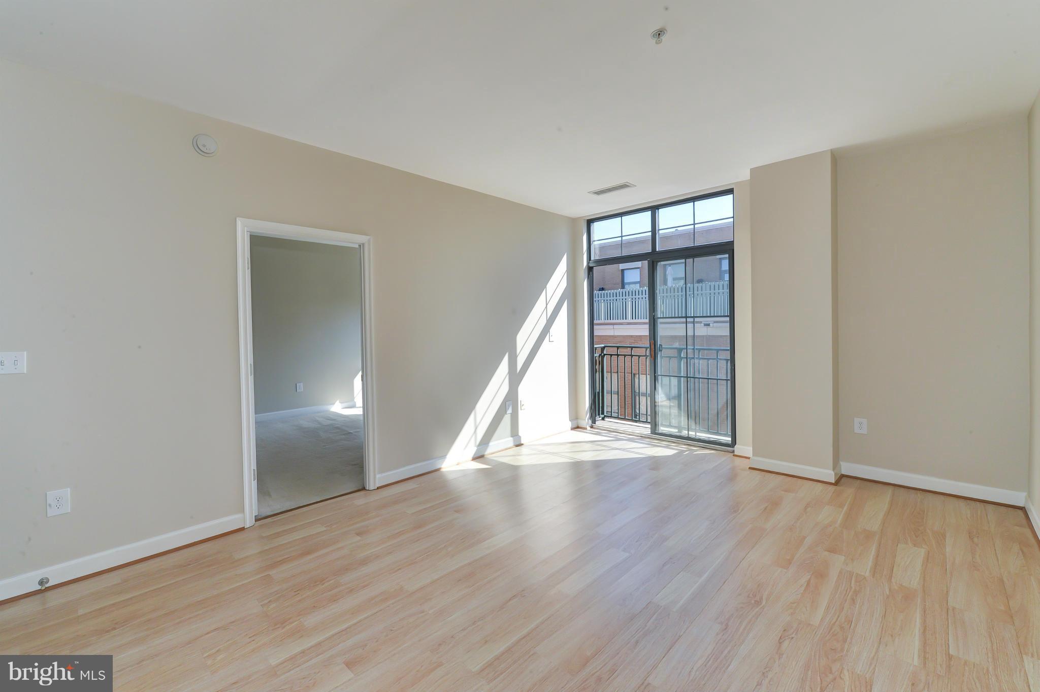 1111 25th Street Northwest, Unit 905 Washington, DC 20037 - Photo 1 of 25 an empty room with wooden floor and windows