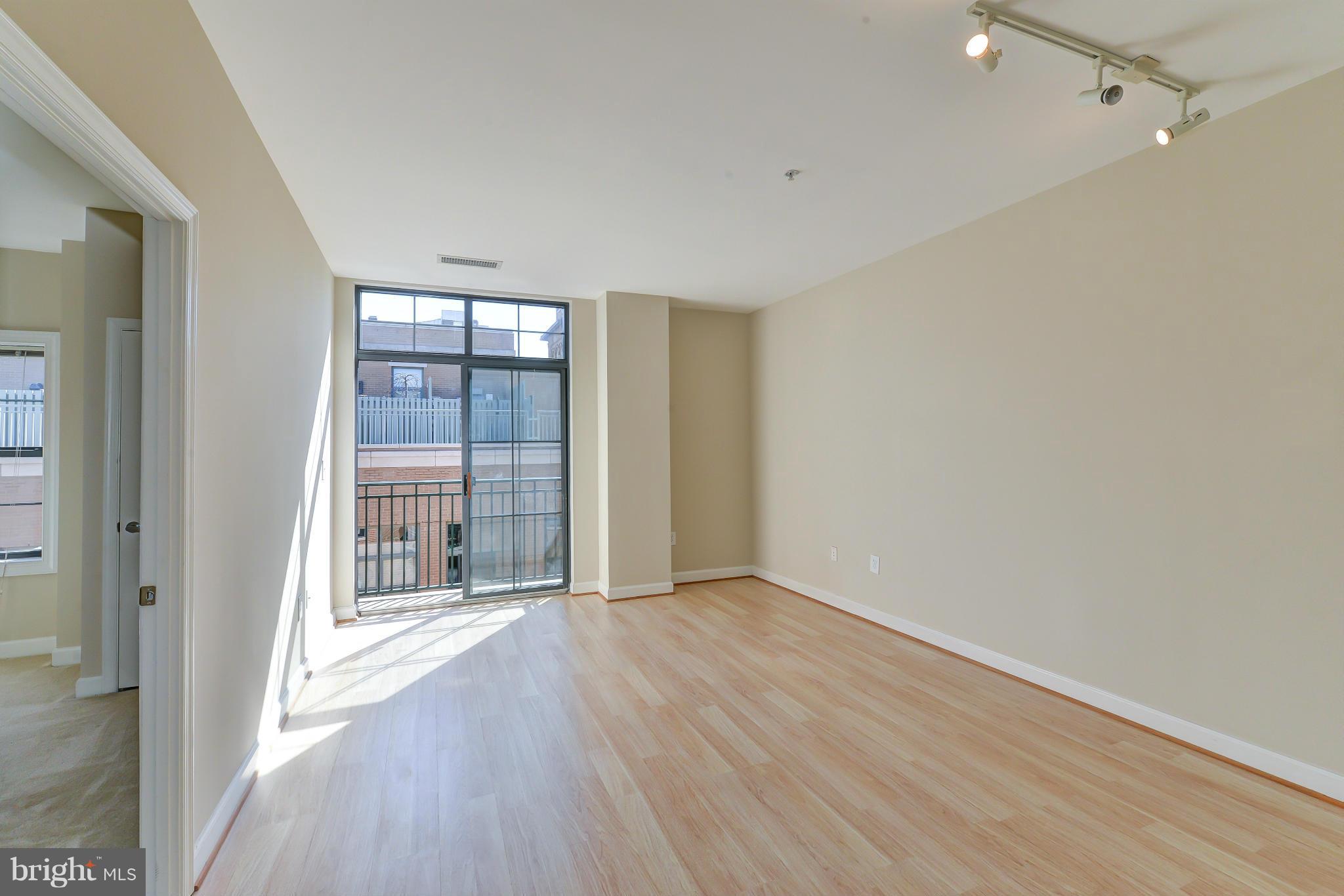 1111 25th Street Northwest, Unit 905 Washington, DC 20037 - Photo 2 of 25 wooden floor in an empty room with a window