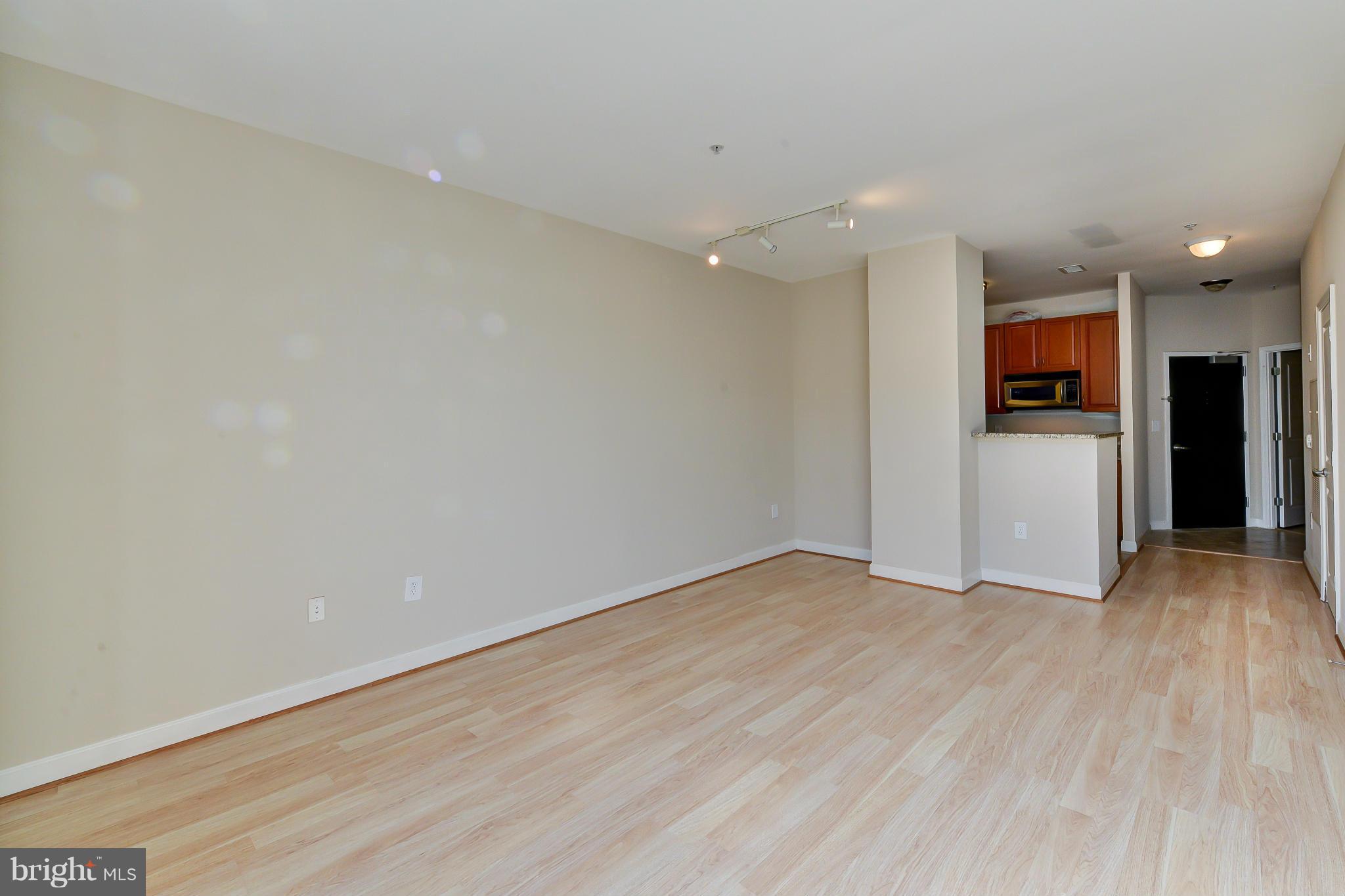 1111 25th Street Northwest, Unit 905 Washington, DC 20037 - Photo 5 of 25 a view of an empty room with wooden floor