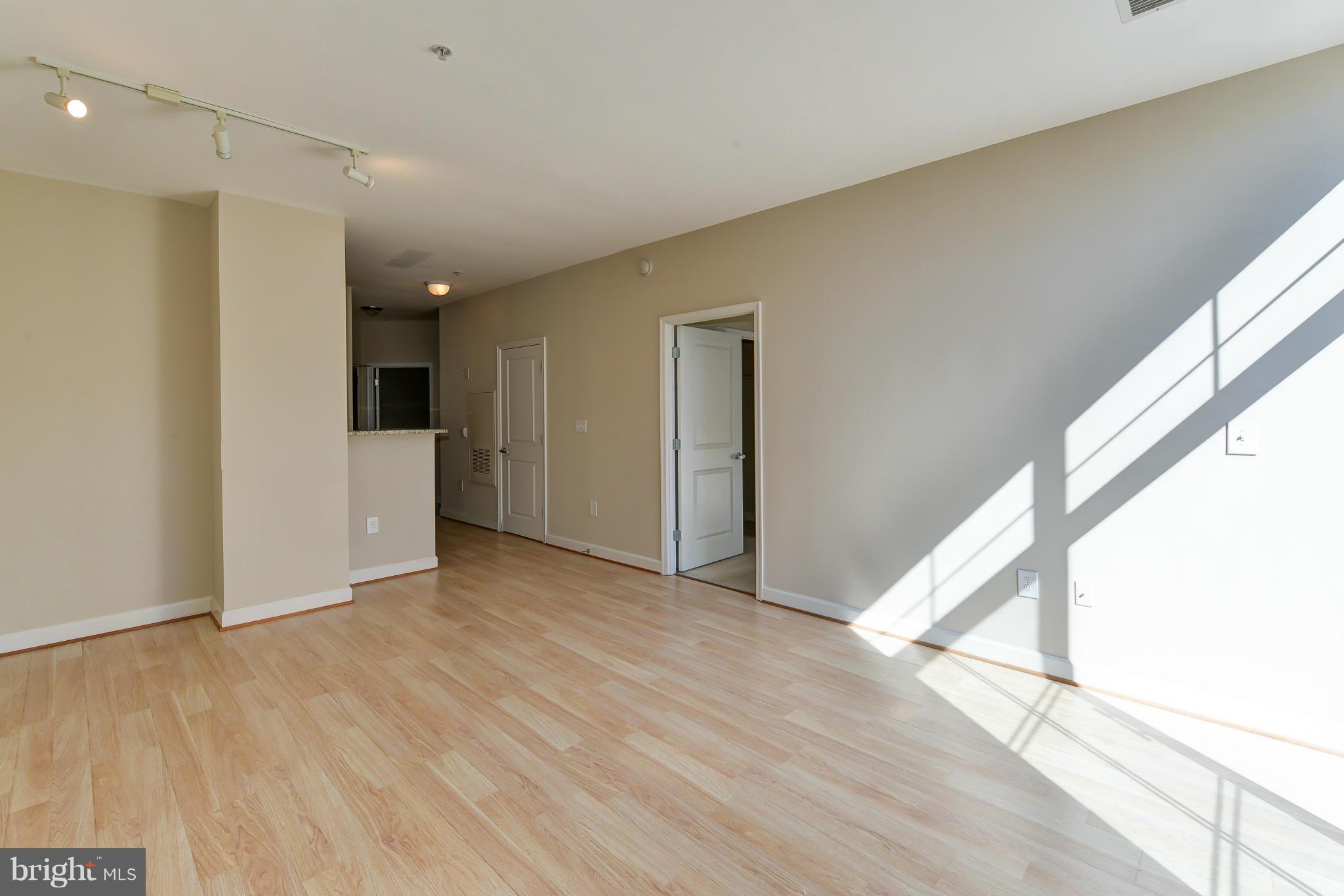 1111 25th Street Northwest, Unit 905 Washington, DC 20037 - Photo 6 of 25 a view of empty room with wooden floor and fan