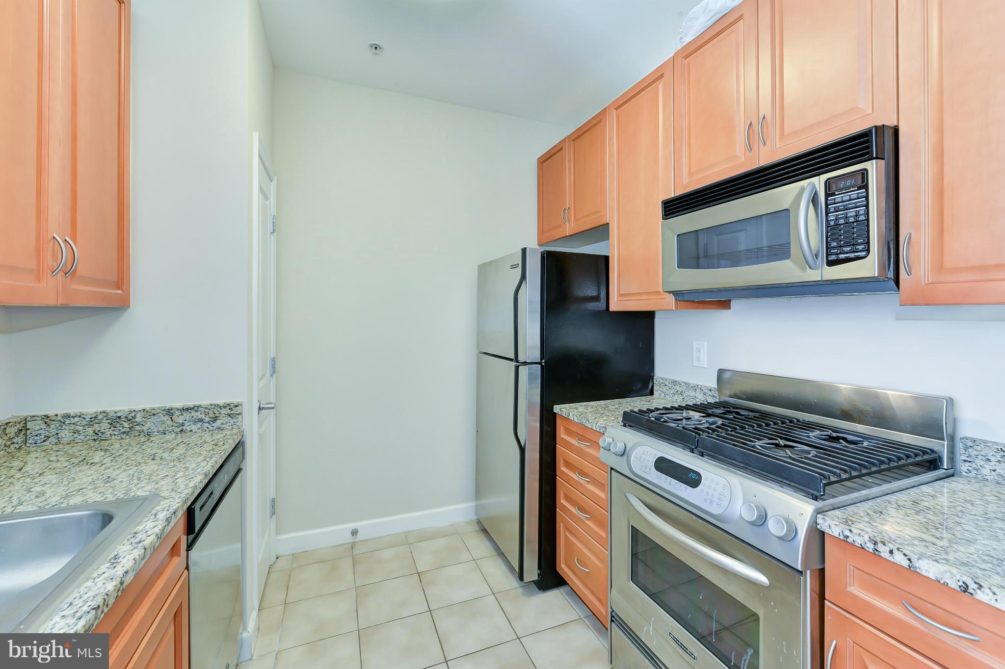 1111 25th Street Northwest, Unit 905 Washington, DC 20037 - Photo 8 of 25 a kitchen with a stove and a microwave
