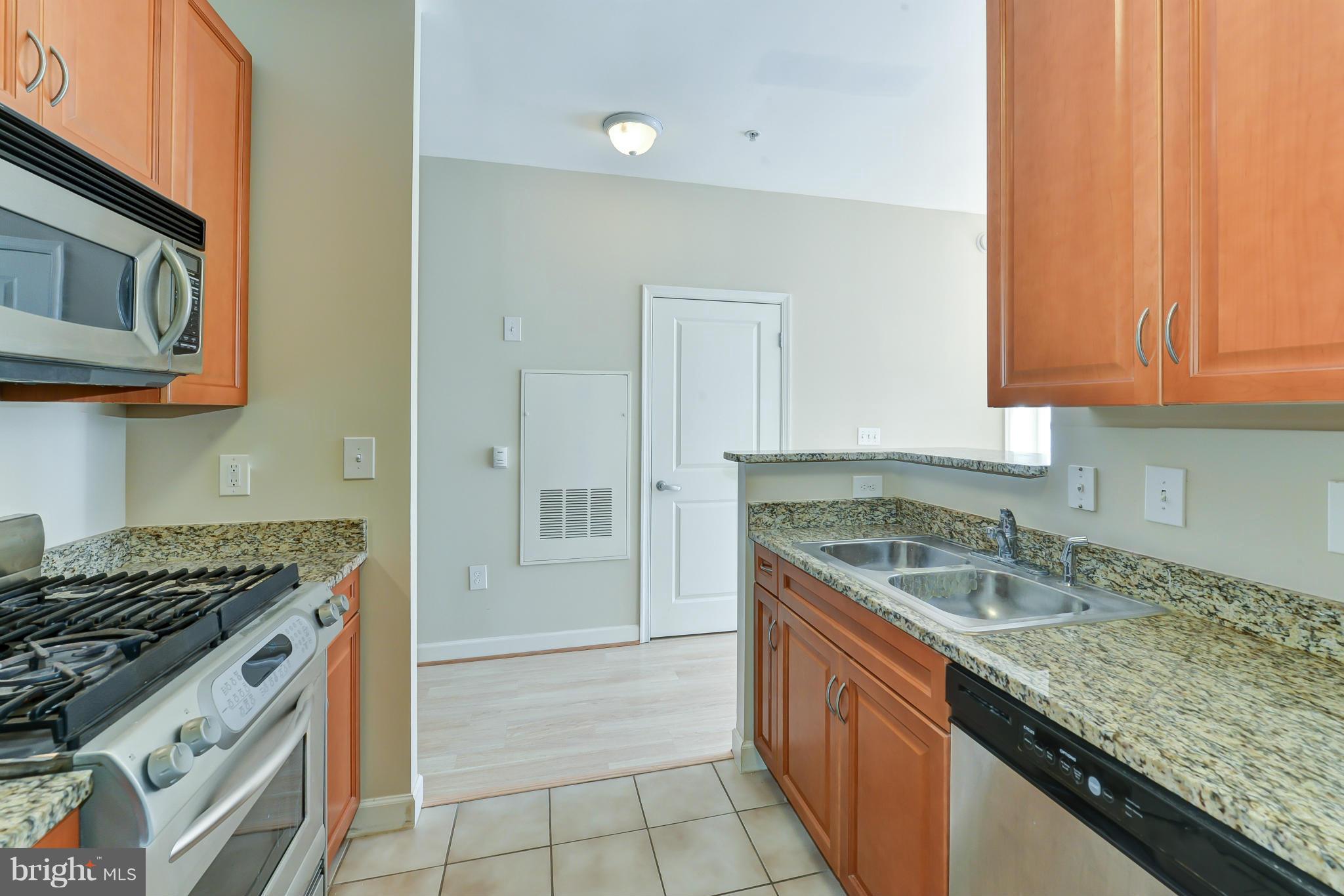 1111 25th Street Northwest, Unit 905 Washington, DC 20037 - Photo 9 of 25 a kitchen with a sink stove and cabinets