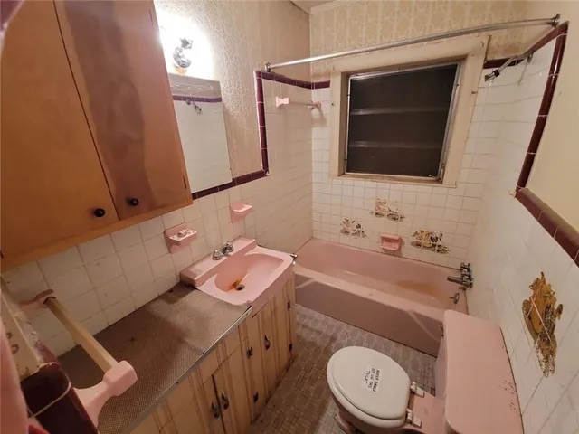 a bathroom with a sink toilet and mirror