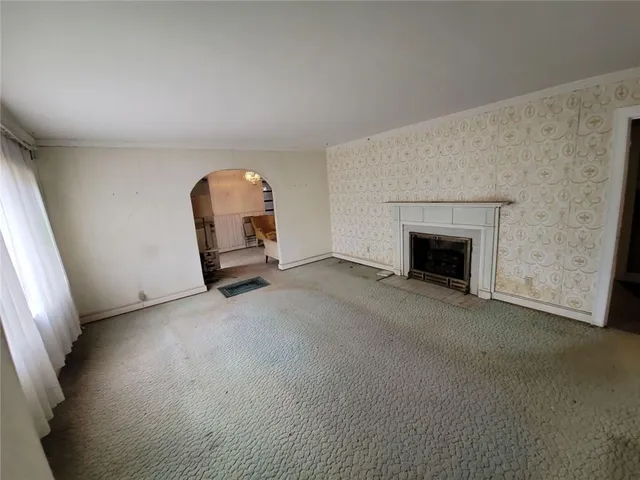 an empty room with furniture and a fireplace