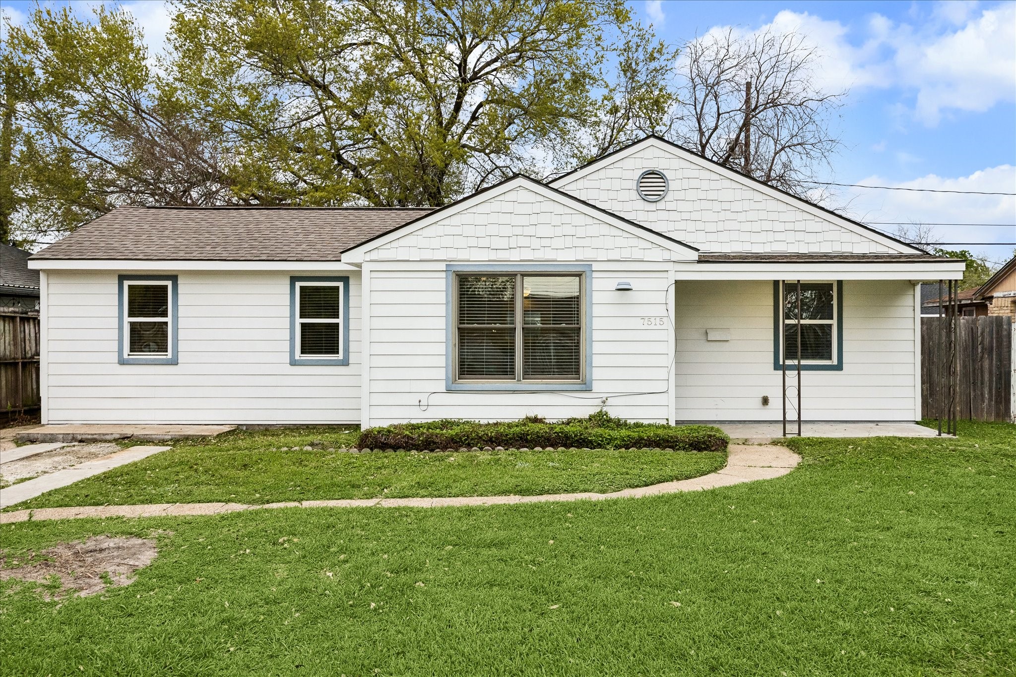 a front view of a house with a garden