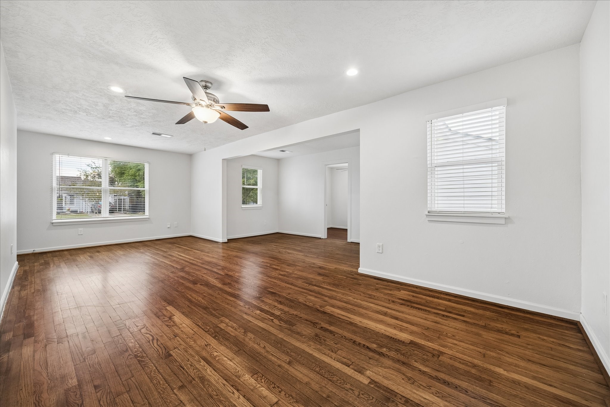 7515 Magnolia Street Houston, TX 77023 - Photo 6 of 16 Alternate view of the main living area looking toward the entry and the adjoining flex space, highlighting the open flow and versatile layout.