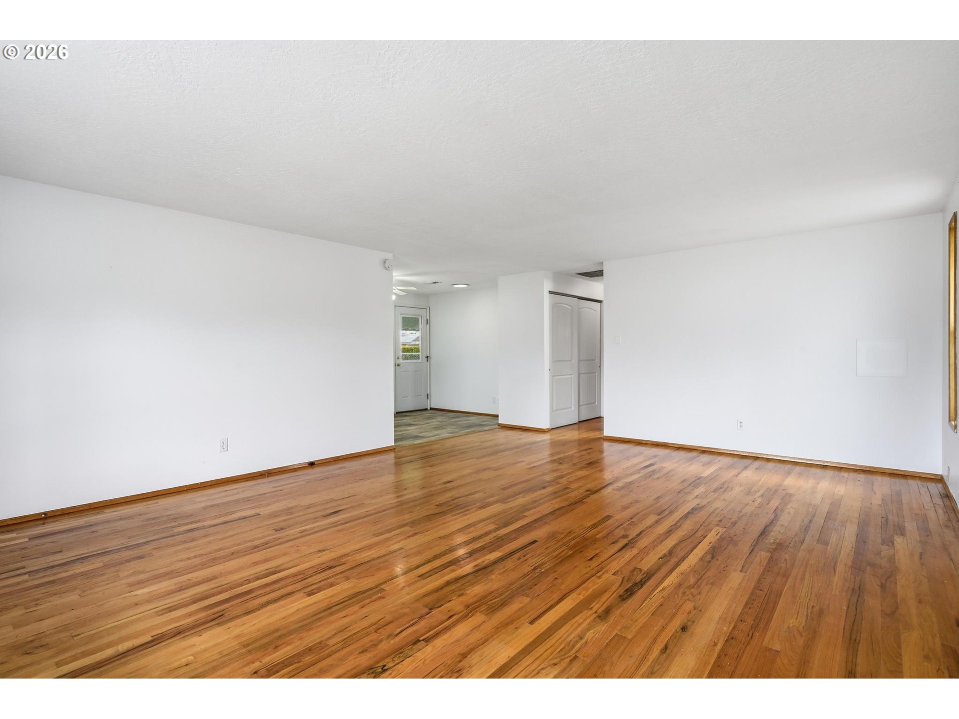 1720 Jansen Way Woodburn, OR 97071 - Photo 6 of 41 a view of an empty room and wooden floor