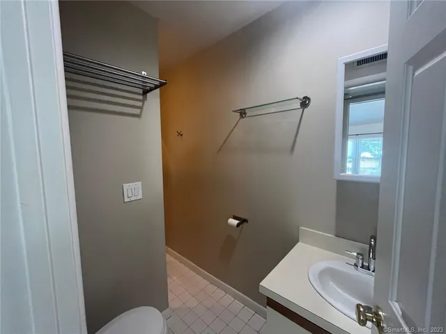 a white toilet sitting next to a shower