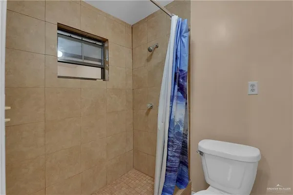 a bathroom with a toilet and a shower