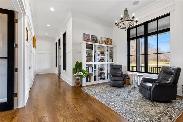 a large white kitchen with granite countertop white cabinets and a sink