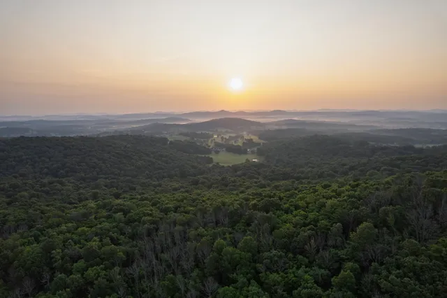 a living room with furniture a flat screen tv and a table