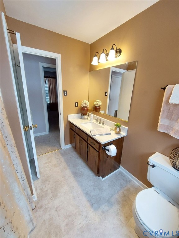 4419 Boones Bluff Way Chesterfield, VA 23832 - Photo 29 of 35 a spacious bathroom with a sink toilet and mirror
