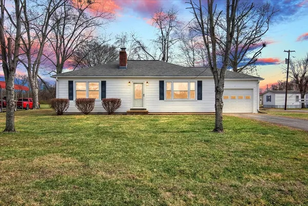 a front view of house with yard and green space