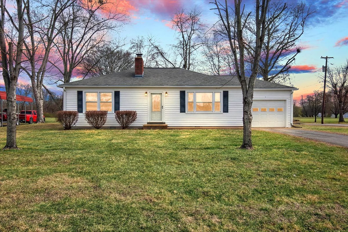 a front view of house with yard and green space
