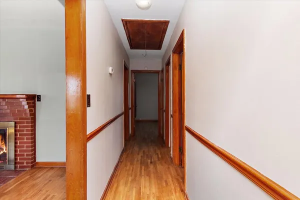 a view of a hallway with wooden floor and staircase