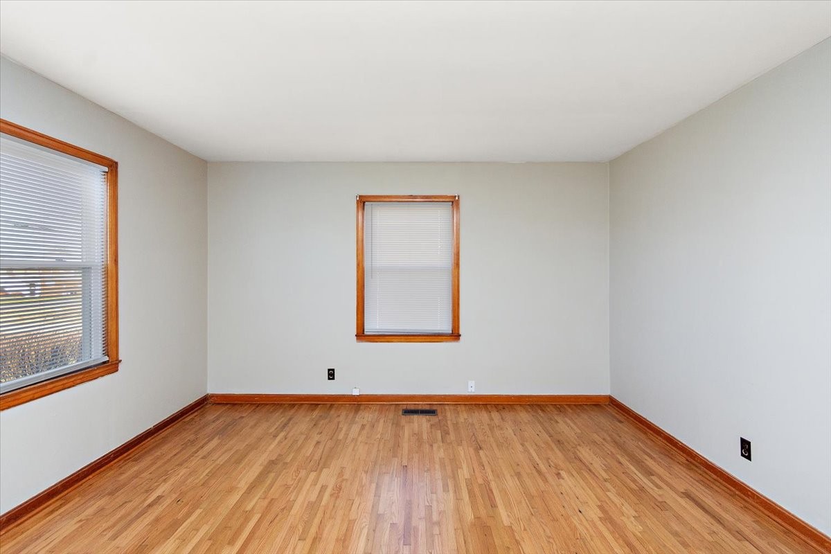 1087 Woods Ferry Road Gallatin, TN 37066 - Photo 18 of 30 a view of an empty room with wooden floor and a window