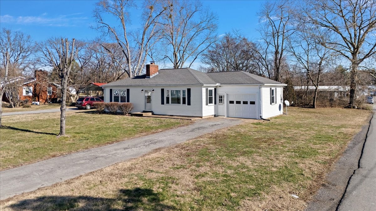 1087 Woods Ferry Road Gallatin, TN 37066 - Photo 3 of 30 a front view of a house with a yard covered with snow and trees