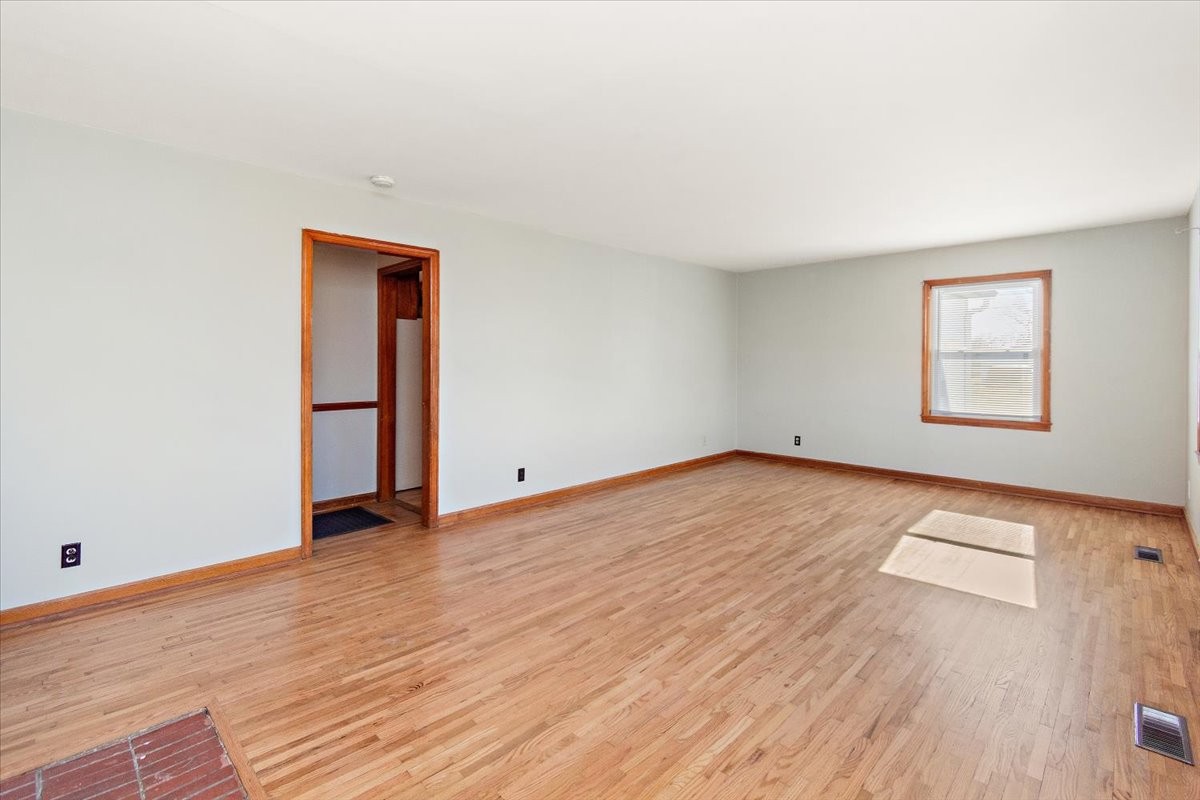 1087 Woods Ferry Road Gallatin, TN 37066 - Photo 7 of 30 an empty room with wooden floor and windows