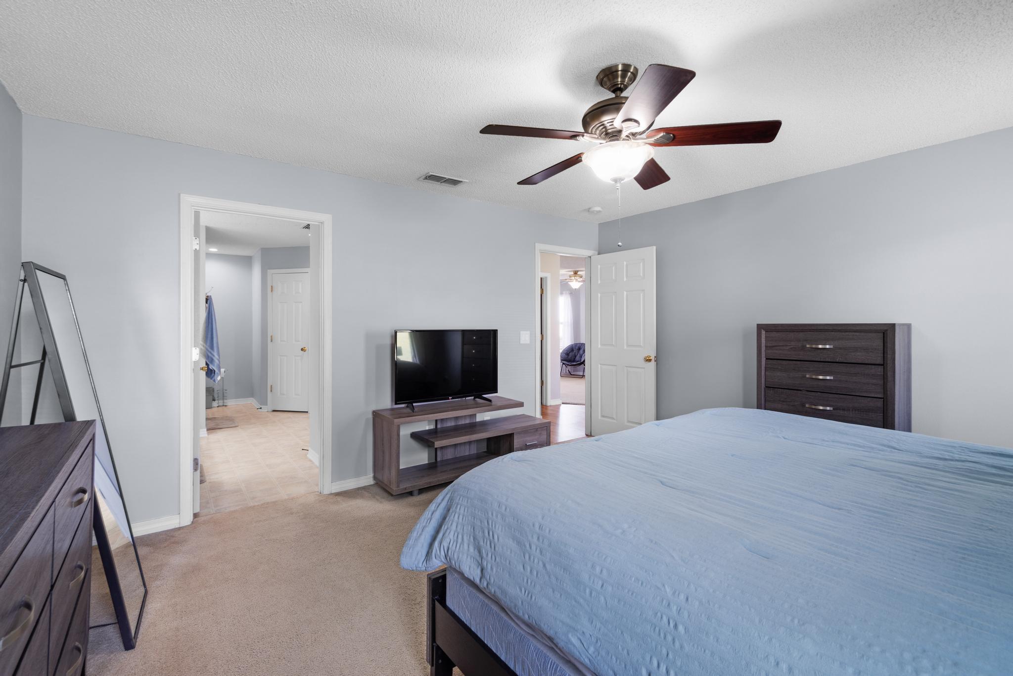 237 Trish Drive Crestview, FL 32536 - Photo 16 of 41 a bedroom with a bed and a flat tv screen on dresser