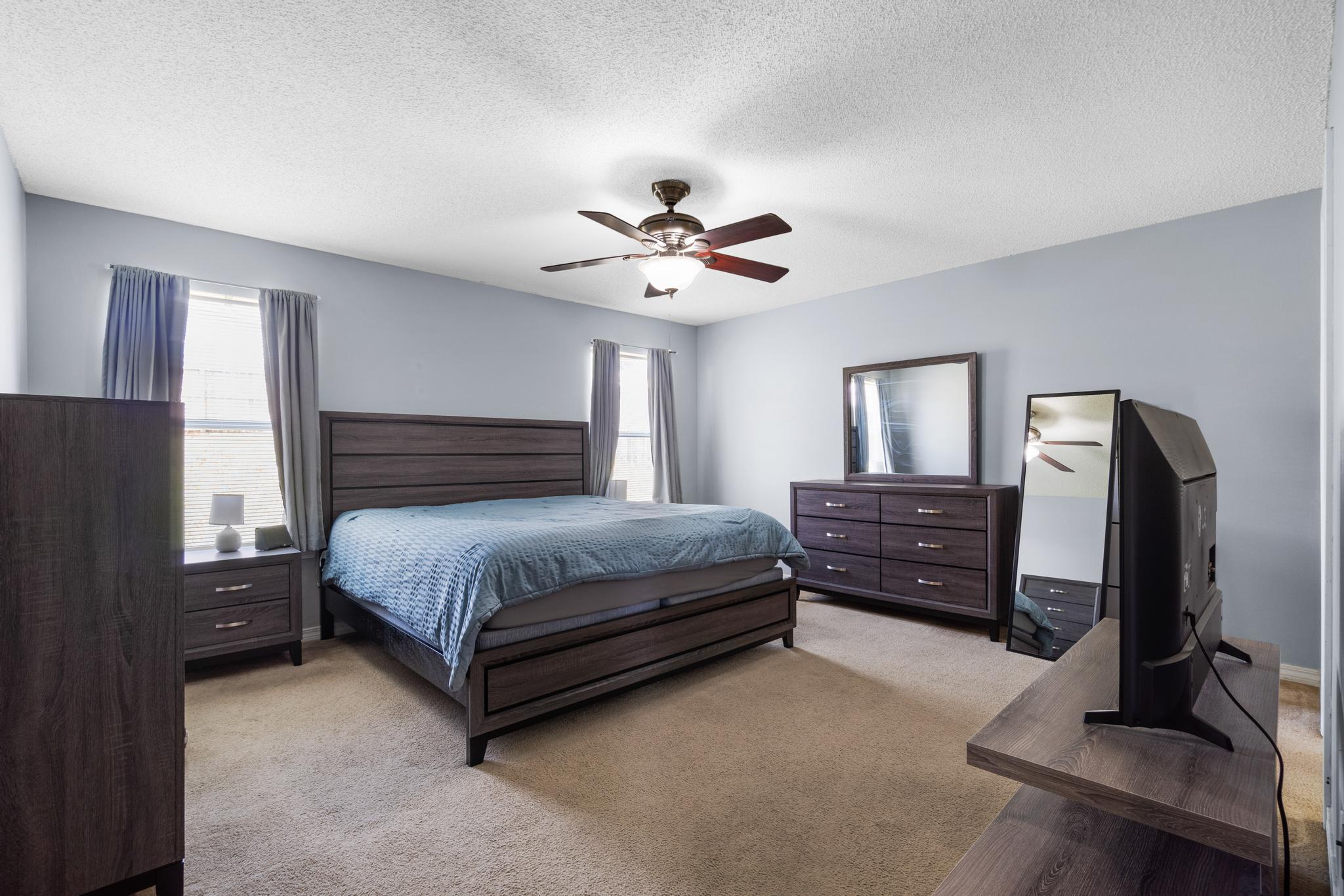237 Trish Drive Crestview, FL 32536 - Photo 17 of 41 a spacious bedroom with a bed and a chandelier