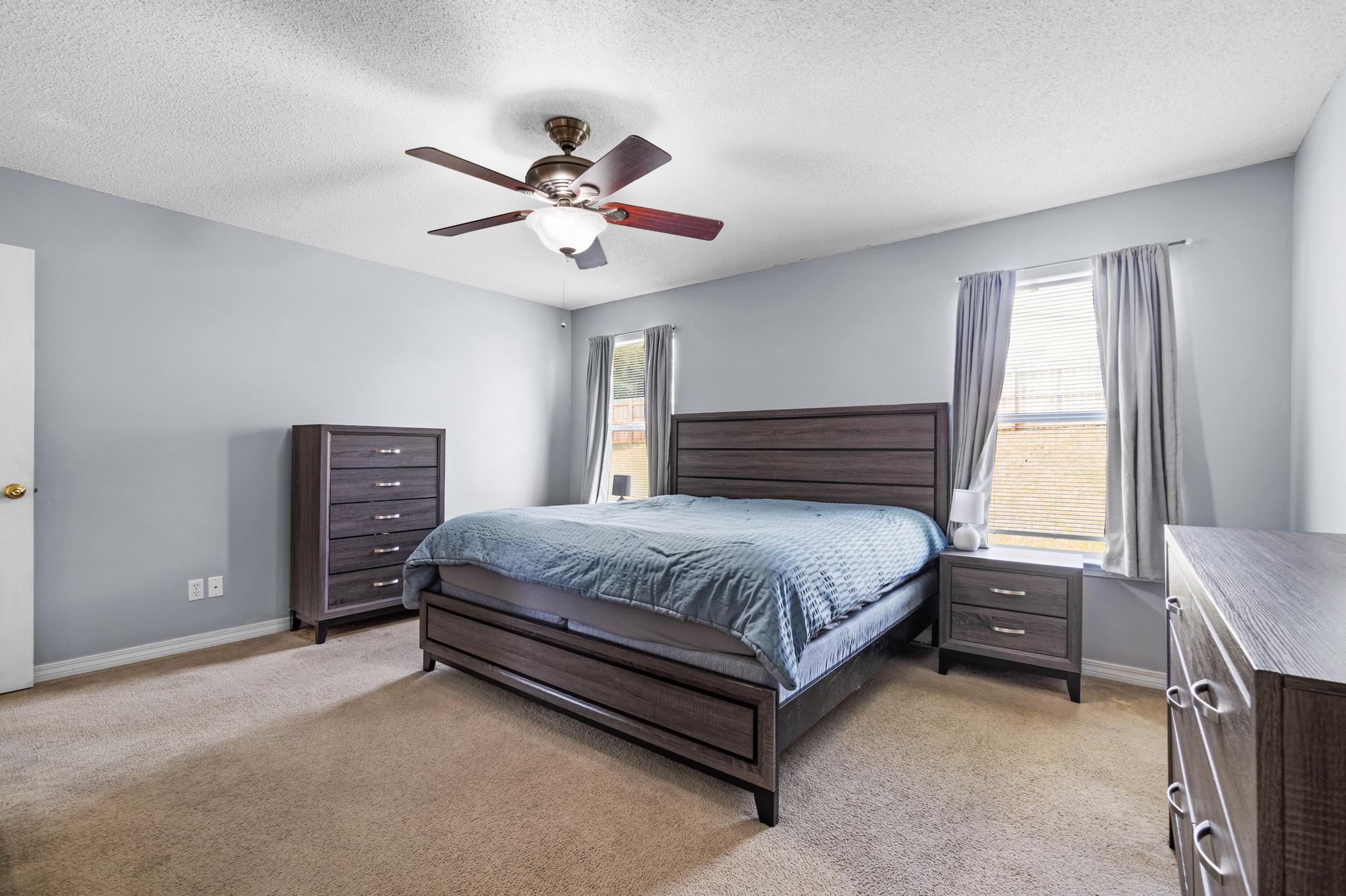 237 Trish Drive Crestview, FL 32536 - Photo 18 of 41 a spacious bedroom with a bed and a chandelier