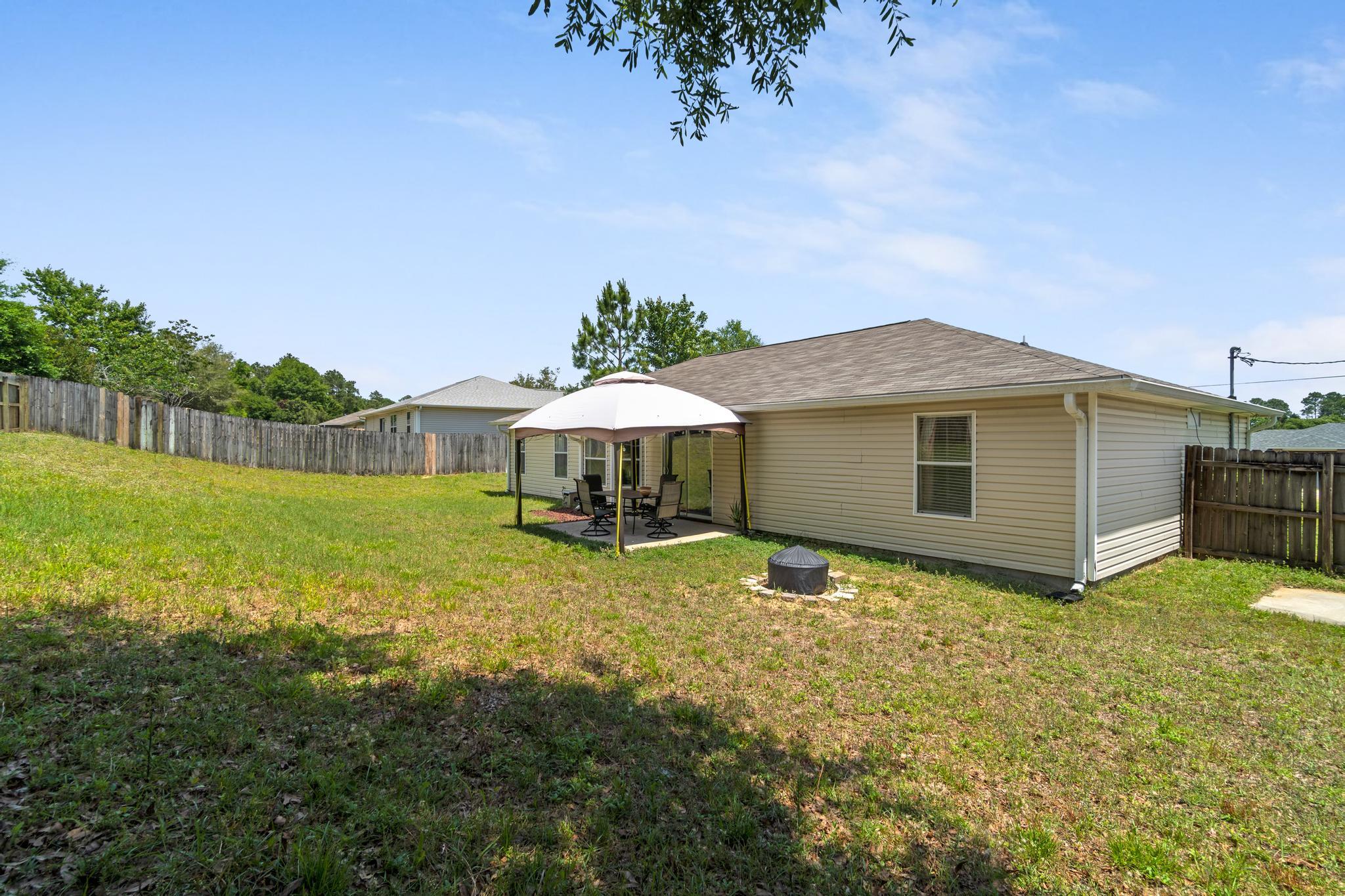 237 Trish Drive Crestview, FL 32536 - Photo 37 of 41 a backyard of a house with table and chairs