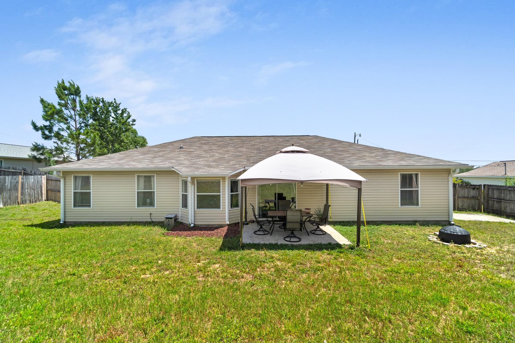 237 Trish Drive Crestview, FL 32536 - Photo 38 of 41 a backyard of a house with table and chairs