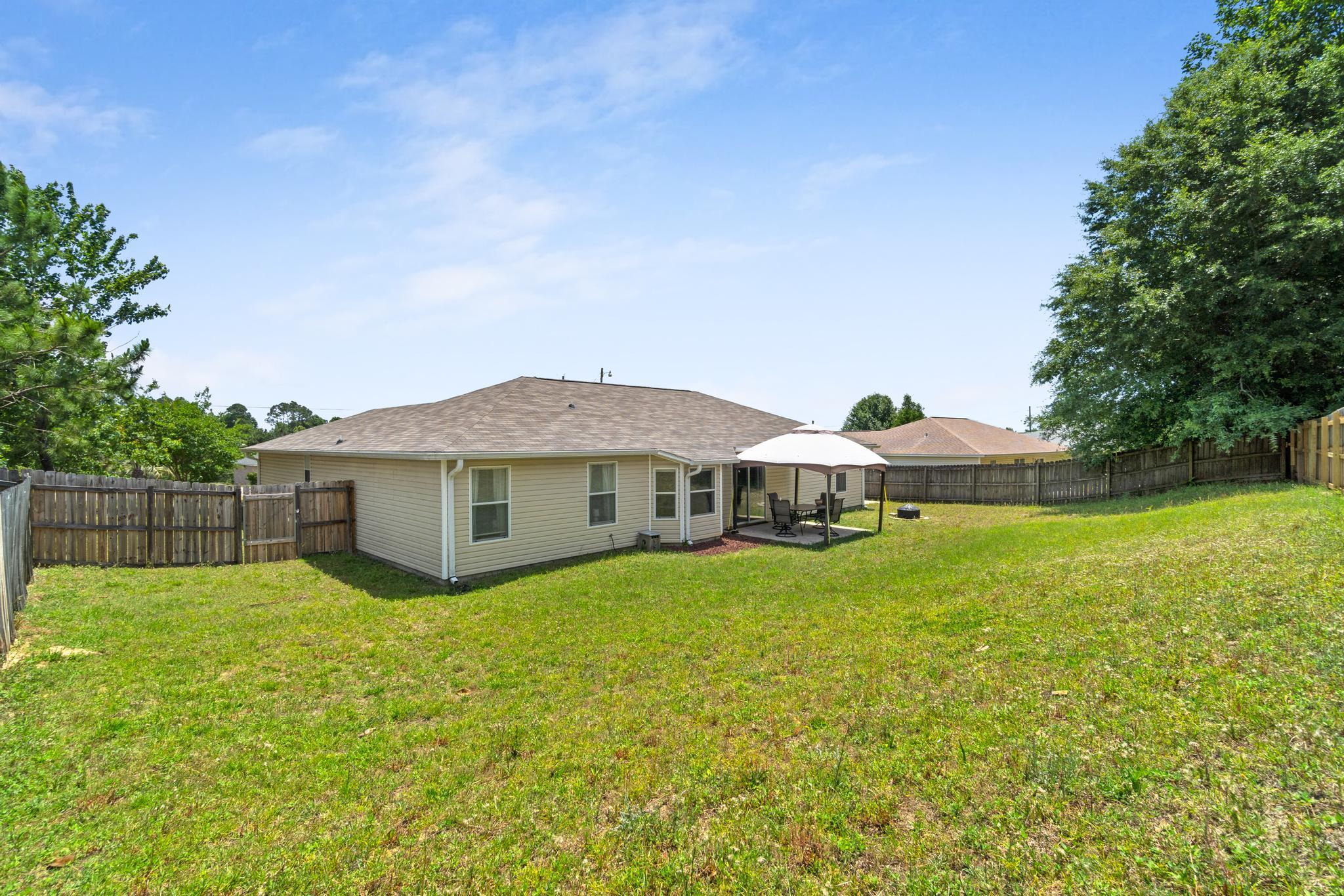 237 Trish Drive Crestview, FL 32536 - Photo 39 of 41 a view of a house with a yard and a large tree