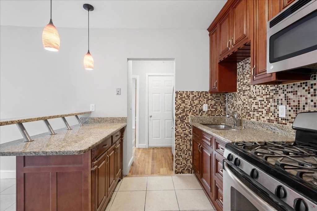 a kitchen with stainless steel appliances granite countertop a stove and a sink