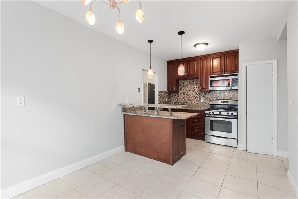 75 Bellevue Street, Unit 2L Boston, MA 02125 - Photo 2 of 10 a kitchen with stainless steel appliances a sink stove and cabinets