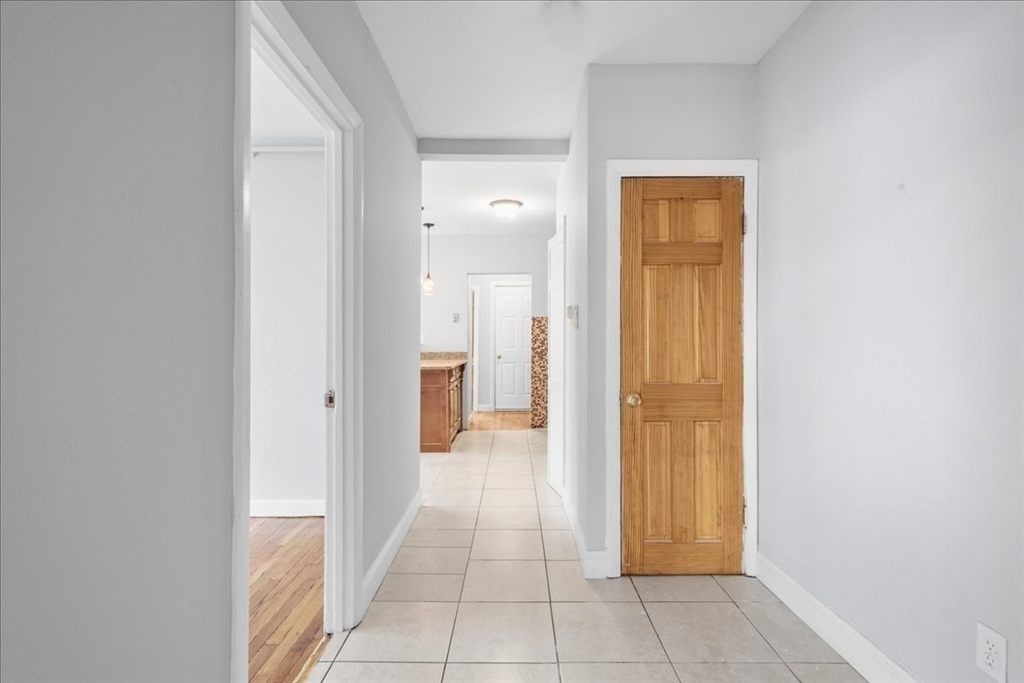 75 Bellevue Street, Unit 2L Boston, MA 02125 - Photo 4 of 10 a view of a hallway with a wooden door