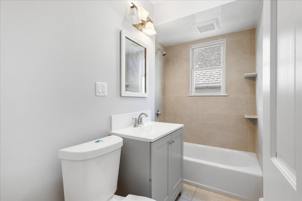 75 Bellevue Street, Unit 2L Boston, MA 02125 - Photo 6 of 10 a bathroom with a sink a toilet and shower
