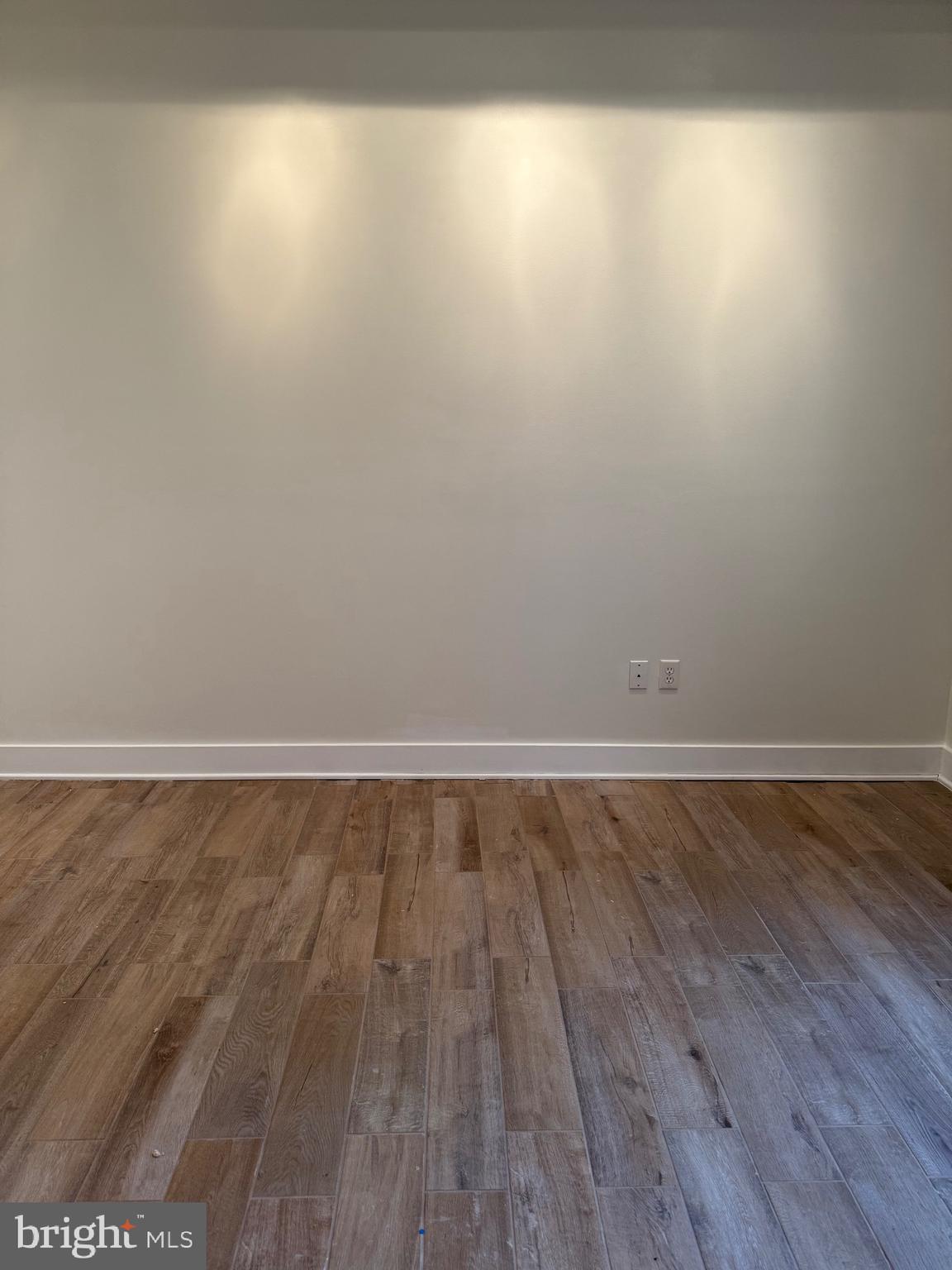 4334 Farragut Street, Unit H Hyattsville, MD 20781 - Photo 5 of 9 a view of an empty room with wooden floor and a window