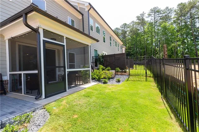 a view of a house with backyard and porch area