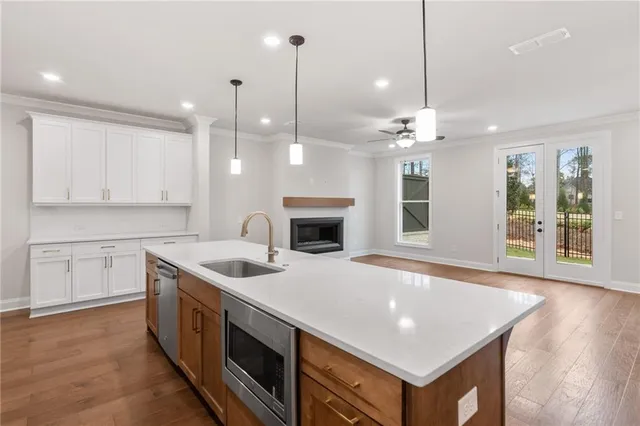 a kitchen with a stove sink and cabinets