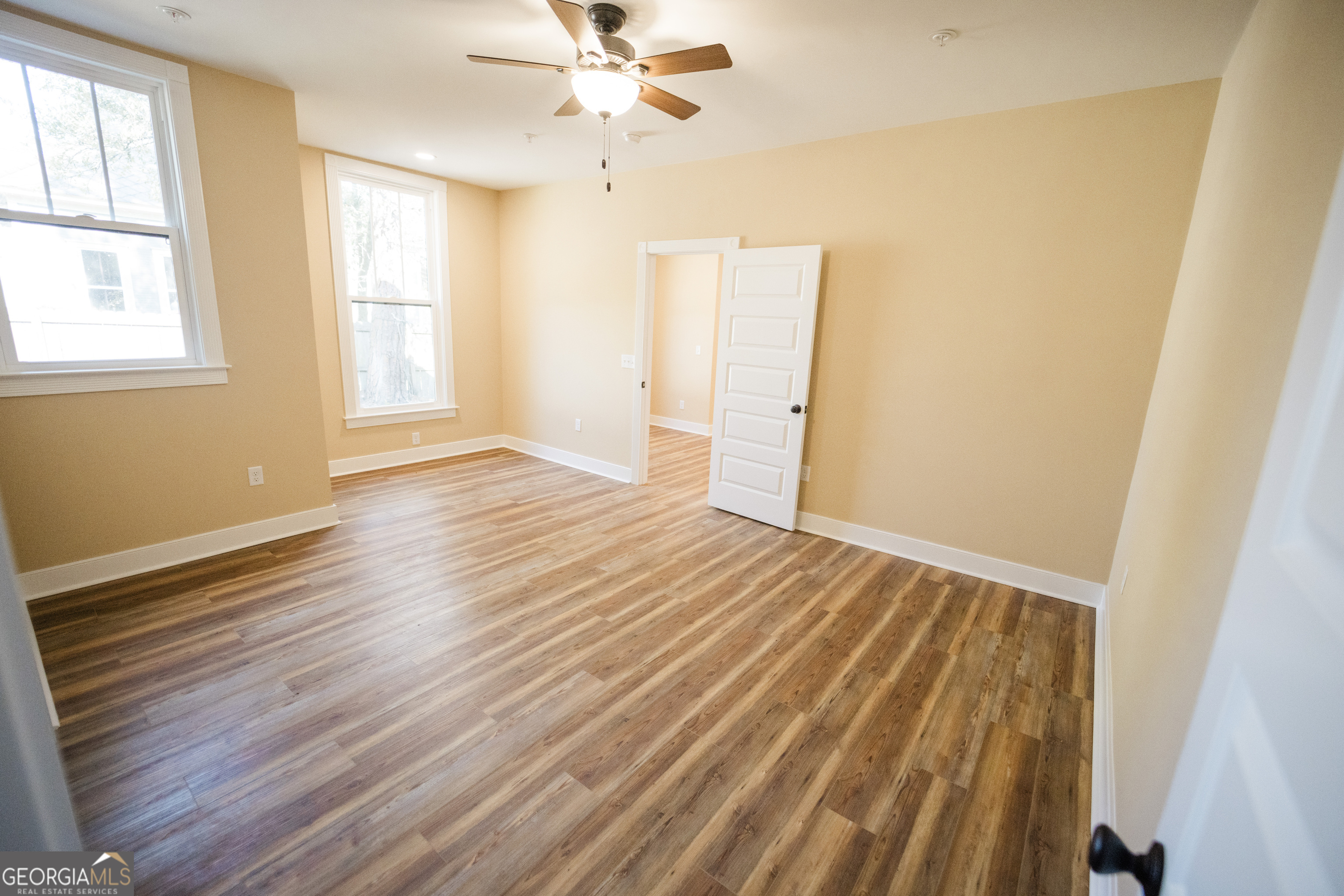 210 West 8th Street, Unit 1 Tifton, GA 31794 - Photo 11 of 23 a view of an empty room with wooden floor and a window