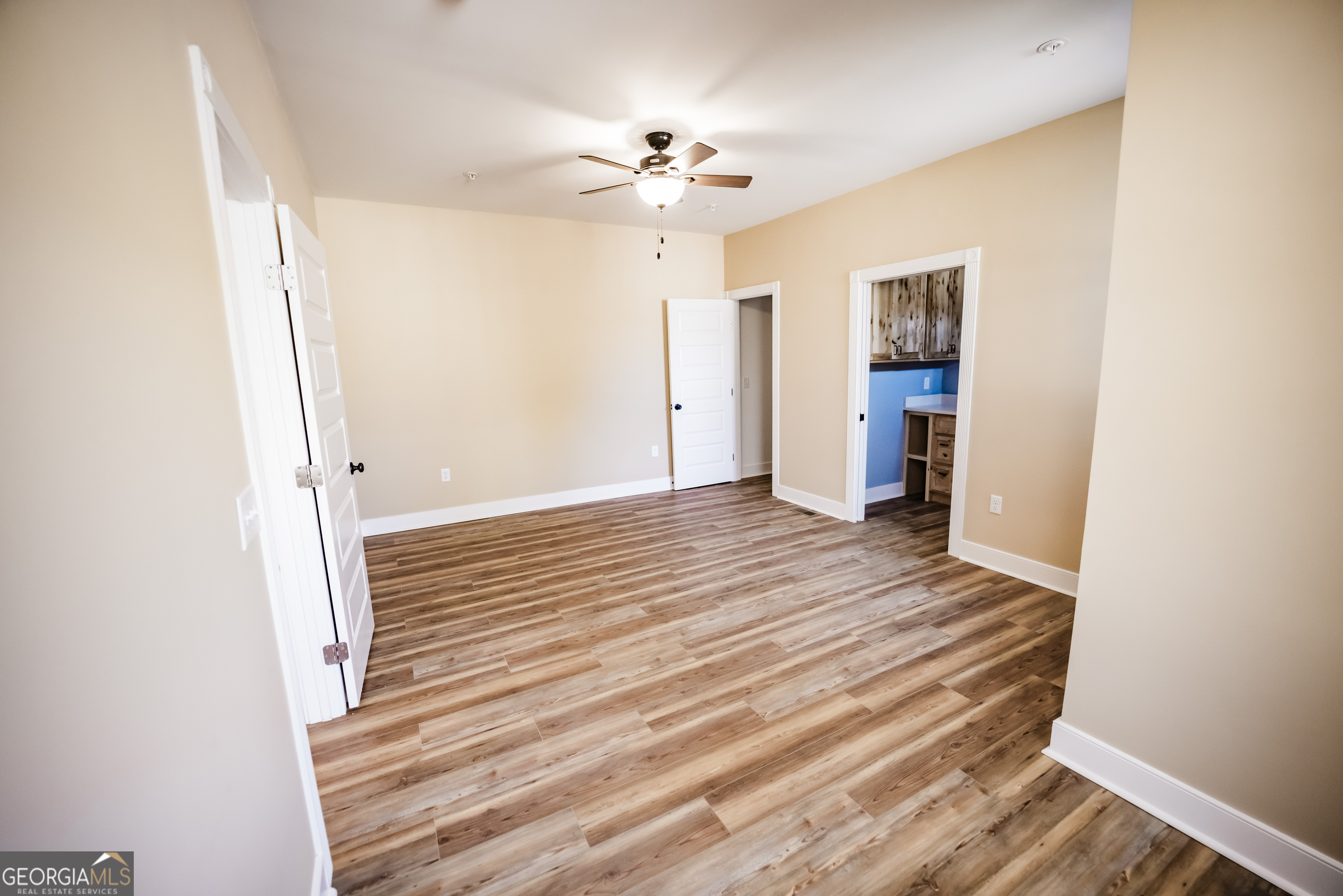 210 West 8th Street, Unit 1 Tifton, GA 31794 - Photo 12 of 23 a view of a livingroom with wooden floor and a ceiling fan
